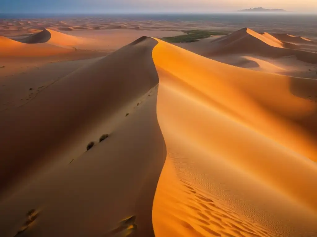 Vista aérea al atardecer del vasto desierto del Sáhara con ruinas antiguas apenas visibles bajo la arena, resaltando la preservación del patrimonio arqueológico africano